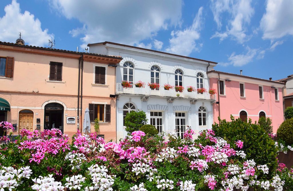 View of Piazza Mattei in Acqualagna with its colorful buildings